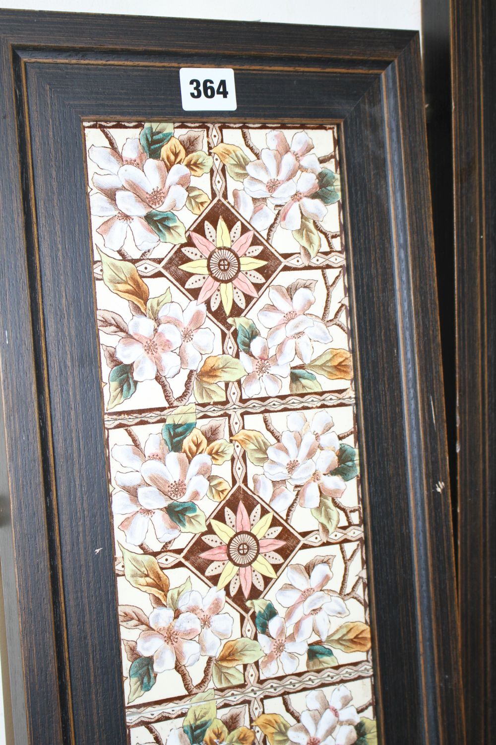 A pair of Victorian apple blossom tile panels and a set of six Art Nouveau foliate design tiles, all framed